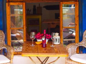 a wooden table with wine glasses and flowers on it at casa limon, El Guro in Valle Gran Rey