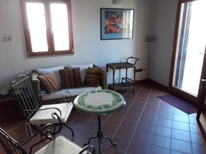 a living room with a couch and a table at L'Antico Pergolato Apartments in Brindisi