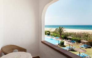 a view from a balcony of a beach with a view of the ocean at Hotel Antonio in Zahara de los Atunes