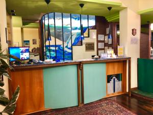 a lobby with a counter with a stained glass window at Hotel Giovanna in Pompei