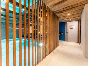 a swimming pool in a room with wooden walls at Mountain Home Villa Anna in Selva di Val Gardena