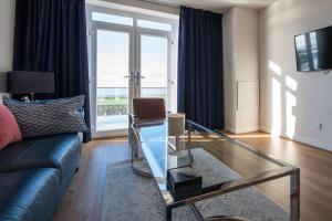 a living room with a couch and a glass table at Stay in Blackpool