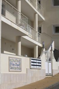 a building with a sign on the side of it at Ericeira Sunset Apartment in Ericeira
