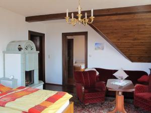 a bedroom with a bed and a couch and a chandelier at Ferienwohnung mit tollem Ausblick in Dresden