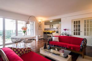a living room with a red couch and a table at Leiria Fatima Nazaré 3 Bedroom House in Leiria