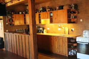 a kitchen with wooden cabinets and a counter top at Raamatu puhkemaja in Jäärja