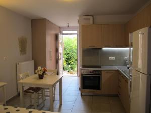 a kitchen with a table and a stove top oven at Muses Studios Sami in Sami