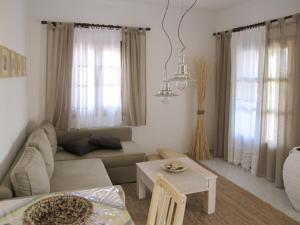 a living room with a couch and a table at Ariston Apartments in Serifos Chora