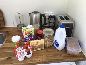 a counter with food ingredients on top of it at Orange Tree Cottage - Harbour view in Opotiki