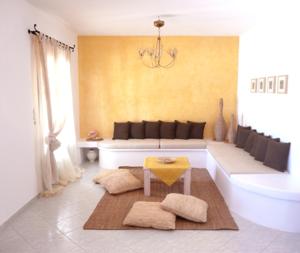 a bathroom with a tub and a table and a sink at Ariston Apartments in Serifos Chora