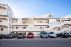a parking lot in front of a large building at Sea View Downtown - Albufeira in Albufeira