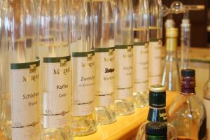 a row of bottles of wine on a wooden table at Hotel Adler Bärental in Feldberg