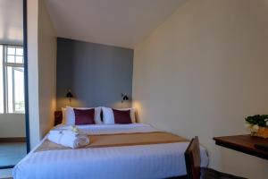 Postel nebo postele na pokoji v ubytování Pakse hotel & Restaurant