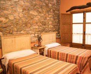 מיטה או מיטות בחדר ב-La Mallada