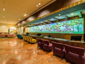 a waiting room with chairs and a large screen at Oriental Hotel Tokyo Bay in Urayasu