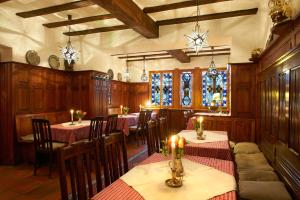 a restaurant with tables and chairs and stained glass windows at Hotel Haus Lipmann in Beilstein