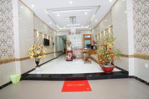 a lobby with vases of flowers and a welcome sign at Thanh Xuan Hotel in Vung Tau