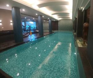 a large swimming pool in a hotel room at PrivateStudio in Quay West Building in Melbourne
