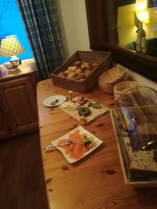 a table with a plate of food and a basket of bread at Gasthof Zur Hohen Hunau in Schmallenberg