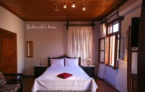 A bed or beds in a room at Under the Clock Tower (Greek Traditional 125m2 home)