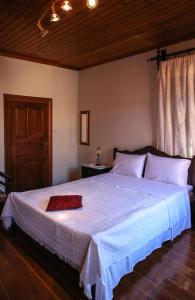 A bed or beds in a room at Under the Clock Tower (Greek Traditional 125m2 home)