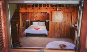 A bed or beds in a room at Under the Clock Tower (Greek Traditional 125m2 home)