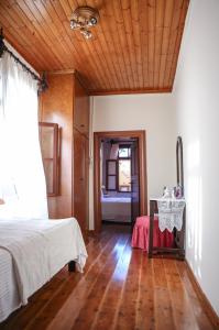 A bed or beds in a room at Under the Clock Tower (Greek Traditional 125m2 home)