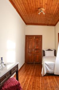 A bed or beds in a room at Under the Clock Tower (Greek Traditional 125m2 home)
