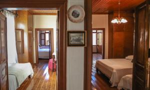 A bed or beds in a room at Under the Clock Tower (Greek Traditional 125m2 home)