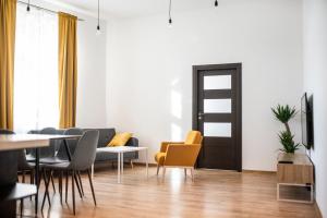 a living room with a table and chairs and a door at WONDER CRACOW in Krakow