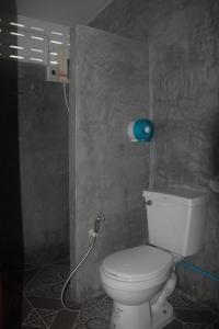 a bathroom with a white toilet in a room at P.L.P Guesthouse - Mae Hong Son in Mae Hong Son