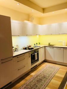 a kitchen with white cabinets and a stove top oven at 365 in Jūrmala