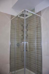 a shower with a glass door in a bathroom at B&b '900 in Foggia