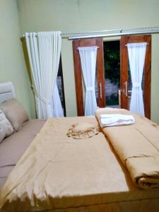 Postel nebo postele na pokoji v ubytování Three V Homestay