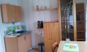 a small kitchen with a sink and a table at Appartement Ferienwohnung Vogel in Hilchenbach +4 photos