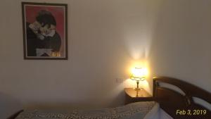 a bedroom with a bed and a picture on the wall at Casa a Soliera in Il Cristo