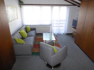 a living room with a couch and a table at Haus Stadel Wohnung Nr. 36 in Albinen