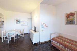 a hotel room with a bed and a desk with a television at Residence Capobianco in Portoferraio