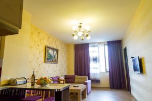 a living room with a couch and a table at Tbilisi Comfort Apartment in Tbilisi City