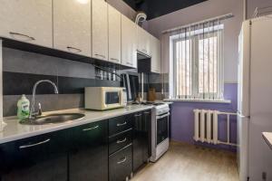 cocina con fregadero y microondas en Apartments for your happiness, en Dnipro