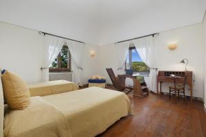 a bedroom with two beds and a desk with a piano at Amore Rentals - Residence Bosco in SantʼAgata sui Due Golfi +80 photos