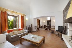 a living room with a couch and a coffee table at Amore Rentals - Residence Bosco in SantʼAgata sui Due Golfi