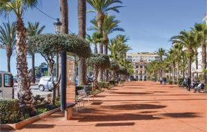 a sidewalk lined with palm trees and a street at LA VILLA DEL PARAISO in Vidreres