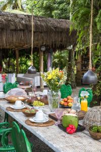 a table with food and drinks and flowers on it at Casas da Vila in Trancoso