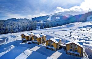 an aerial view of a resort in the snow at Chalets Minerália in Demanovska Dolina