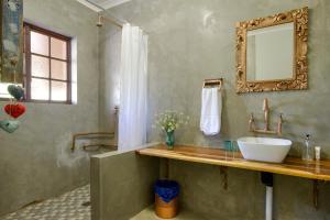 a bathroom with a sink and a mirror at Marlin Lodge St Lucia in St Lucia