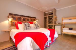 a bedroom with a large bed and two bunk beds at Marlin Lodge St Lucia in St Lucia