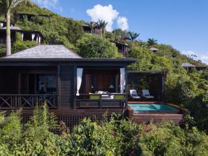 a house on a hill with a swimming pool at Hermitage Bay - All Inclusive in Saint Johnʼs