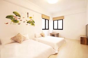 Postel nebo postele na pokoji v ubytování Zih Yue Tong Homestay II