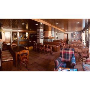a restaurant with chairs and tables and a bar at Aparthotel Es de Don Joan in Unha +23 photos